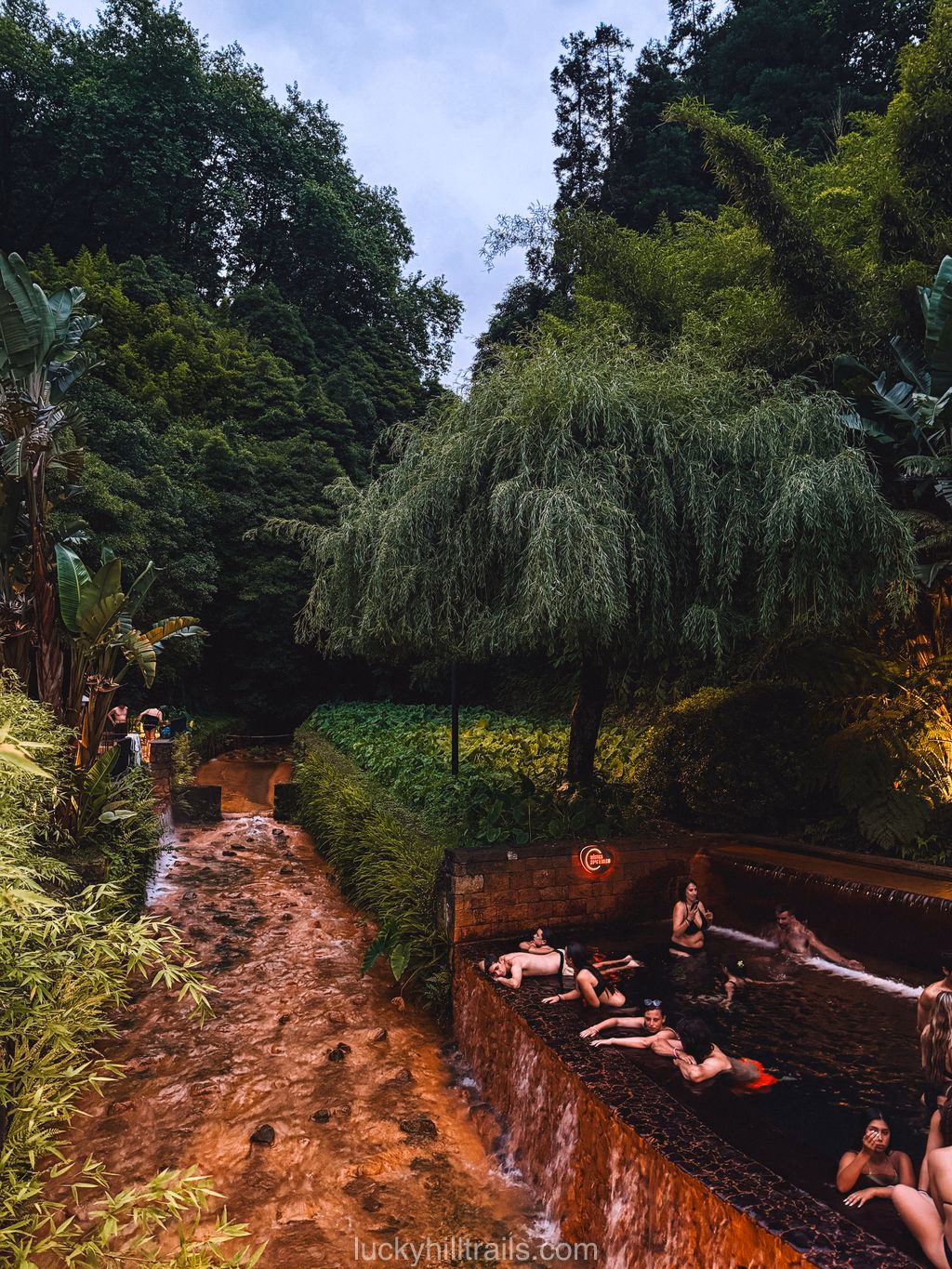 Visitors soaking in a warm pool during the night session at Poça da Dona Beija, São Miguel, Azores