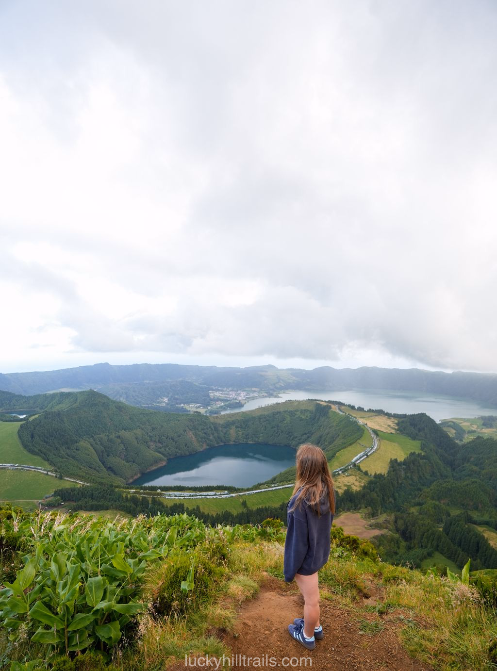 Narrow Grota do Inferno viewpoint with a wooden fence in the fog, São Miguel, Azores