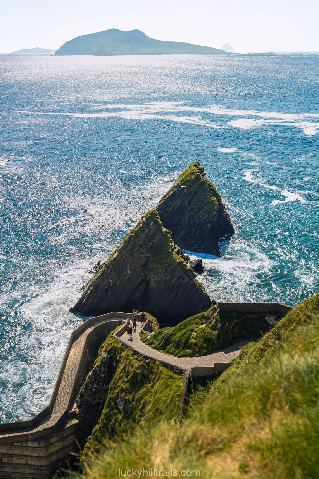 The winding descent of Dunquin Pier to the Atlantic Ocean with views of the rocky Blasket Islands, Dingle Peninsula, Ireland