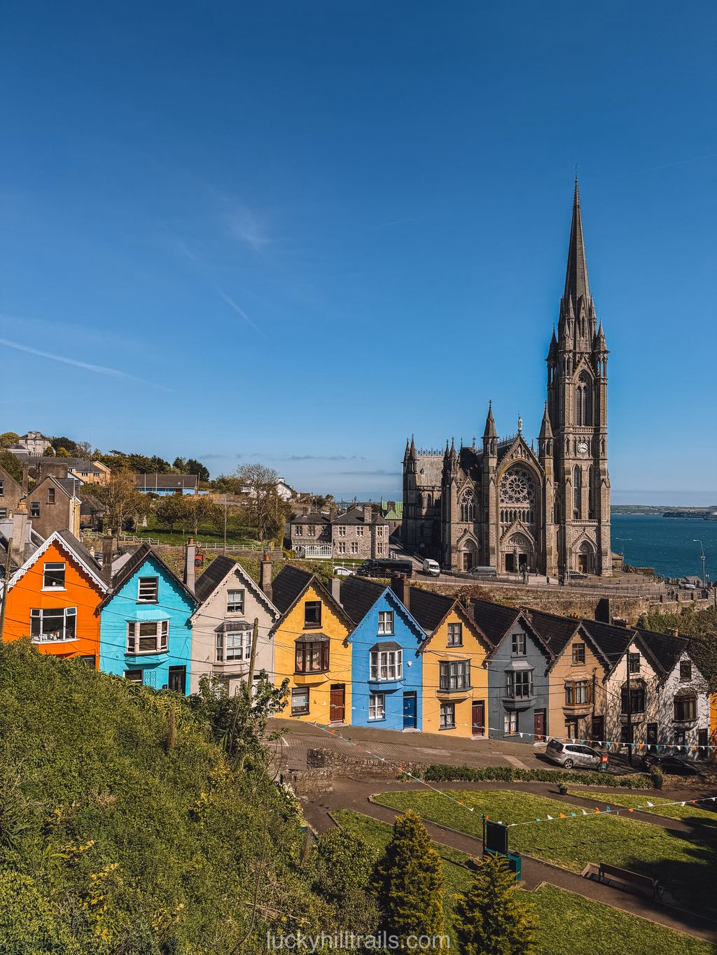 Colourful Deck of Cards houses against the Gothic St Colman's Cathedral, Cobh, Ireland