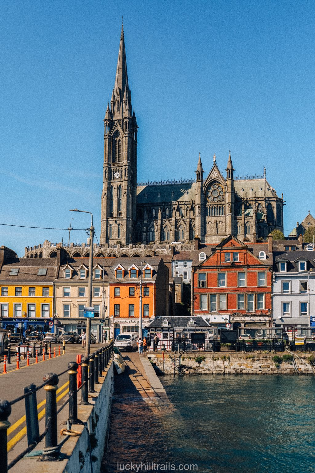Cobh waterfront with colourful buildings and the Gothic St Colman's Cathedral, Ireland