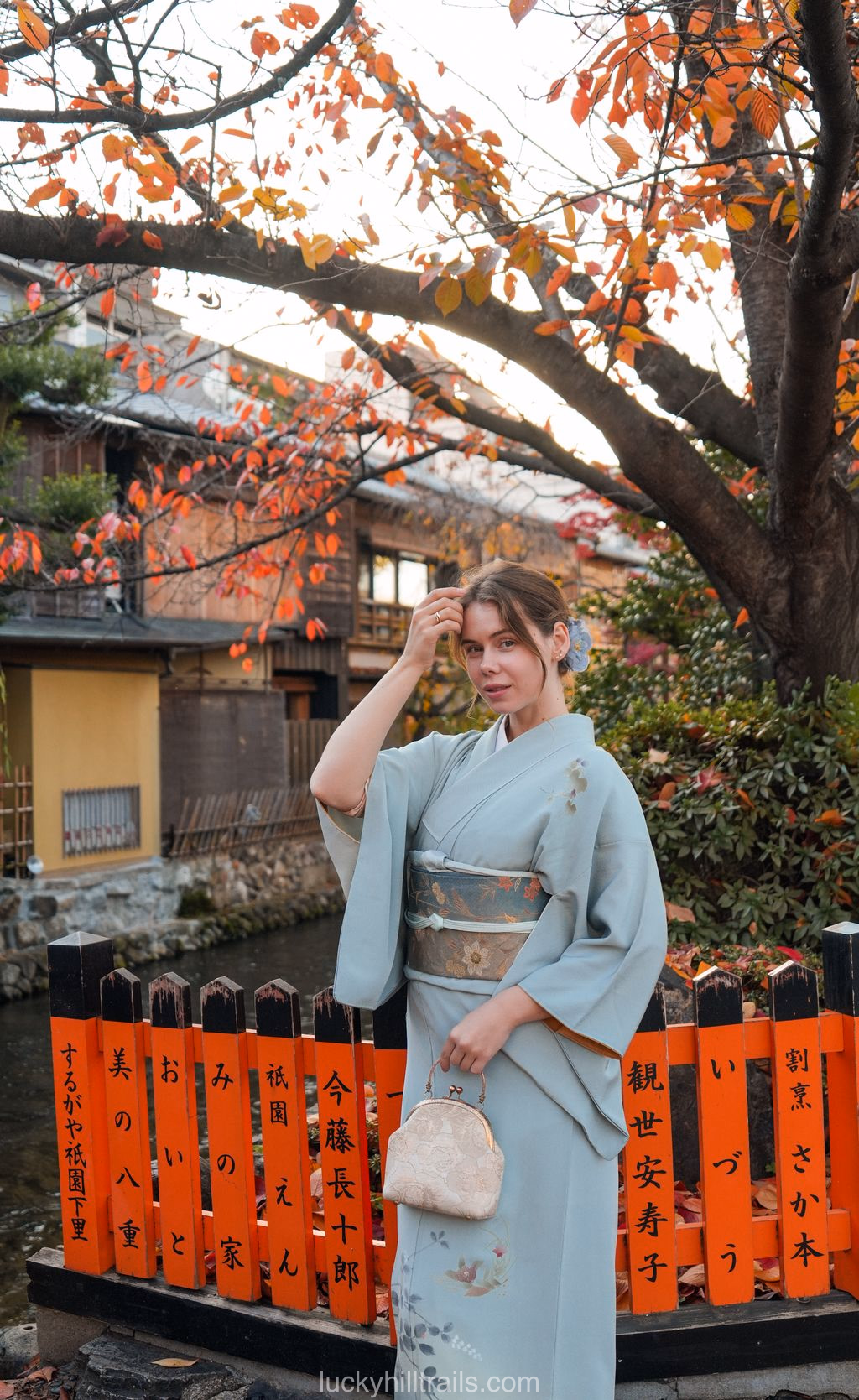 Girl in a blue kimono against orange lanterns in the Gion district, Kyoto