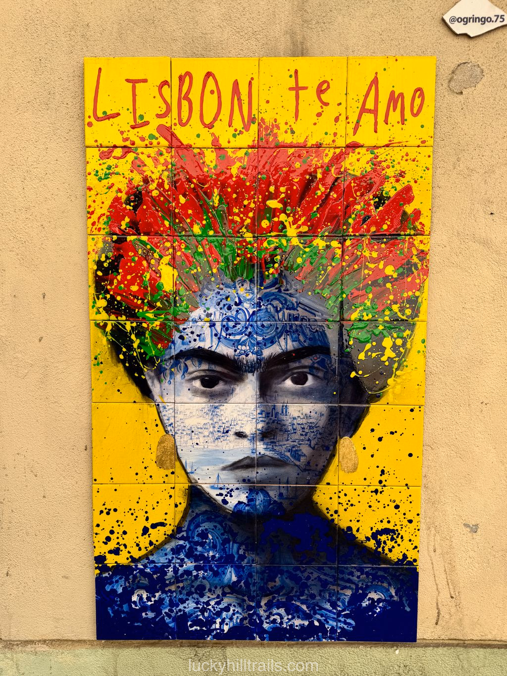 Street art mural at LX Factory with a portrait and the inscription "Lisbon te Amo" with colorful paint splashes, Lisbon, Portugal