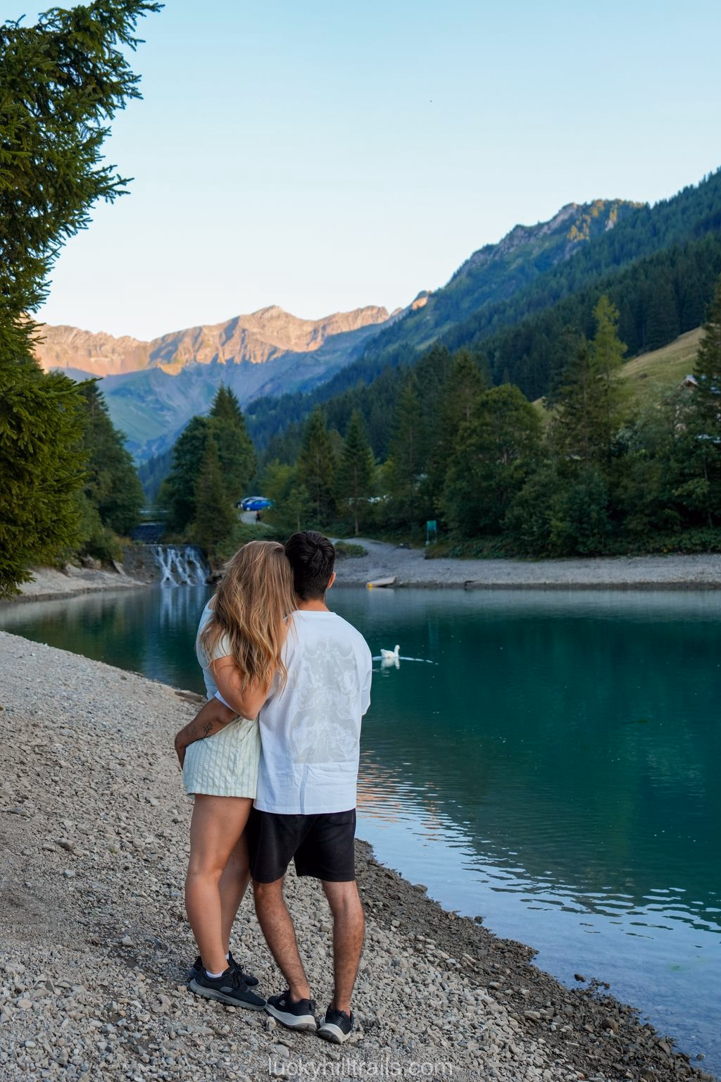 A couple embracing on the shore of Lake Gänglesee