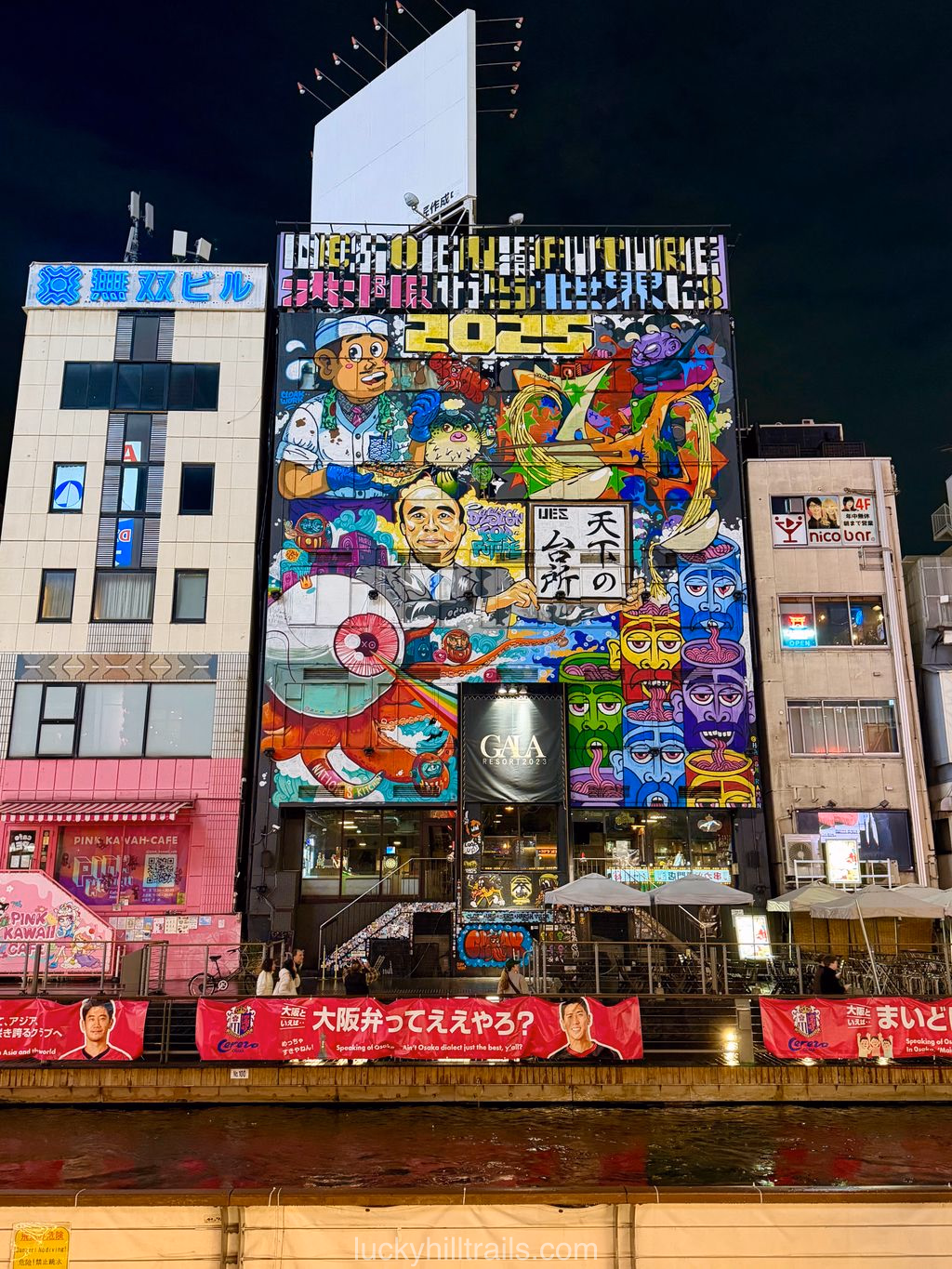 A vivid graffiti mural on a building in the Dotonbori district at night, Osaka