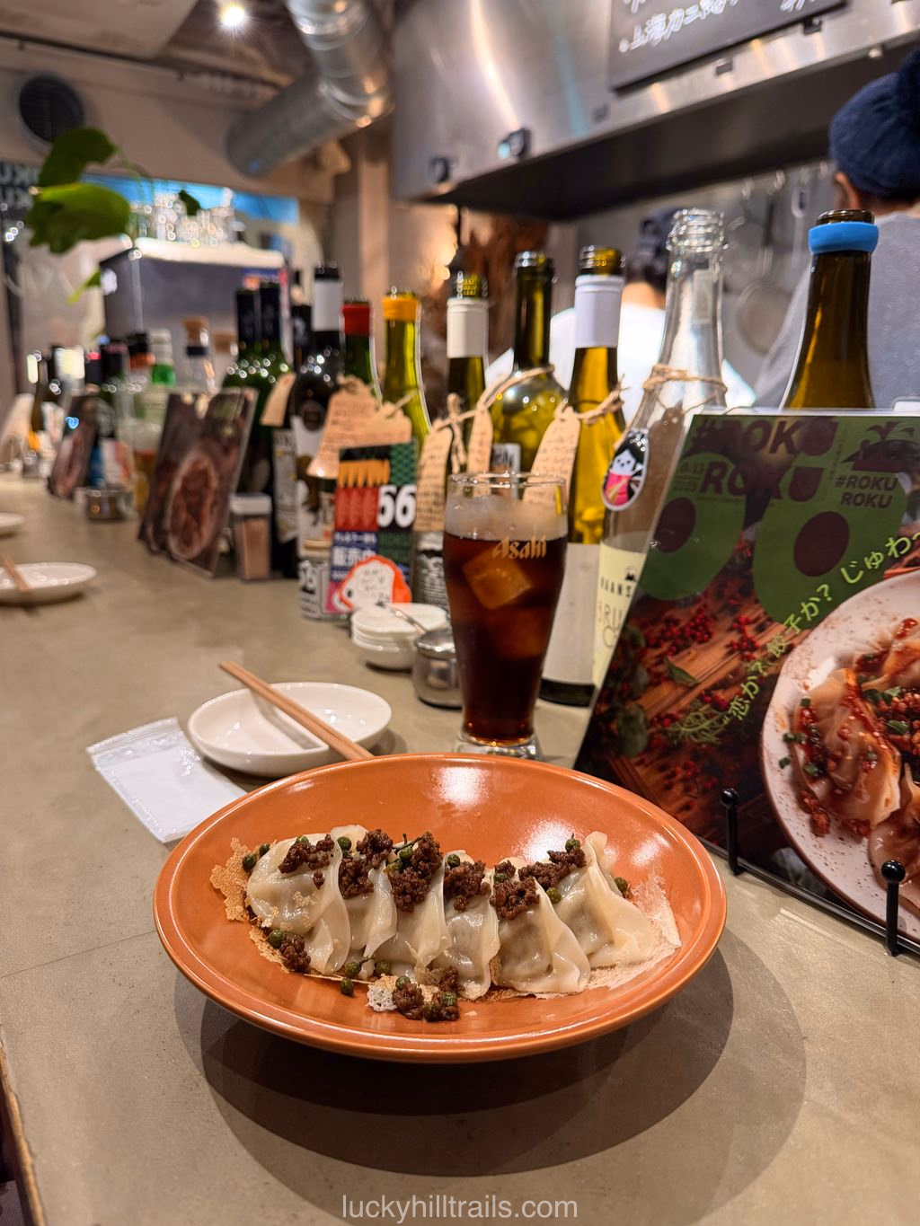 Fried Japanese gyoza dumplings on a plate at #ROKUROKU餃子バル, Osaka
