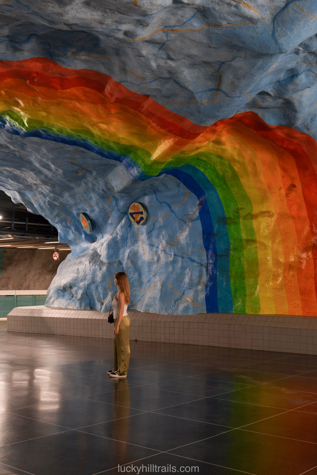 Large rainbow in the sky-blue tunnel of Stadion station